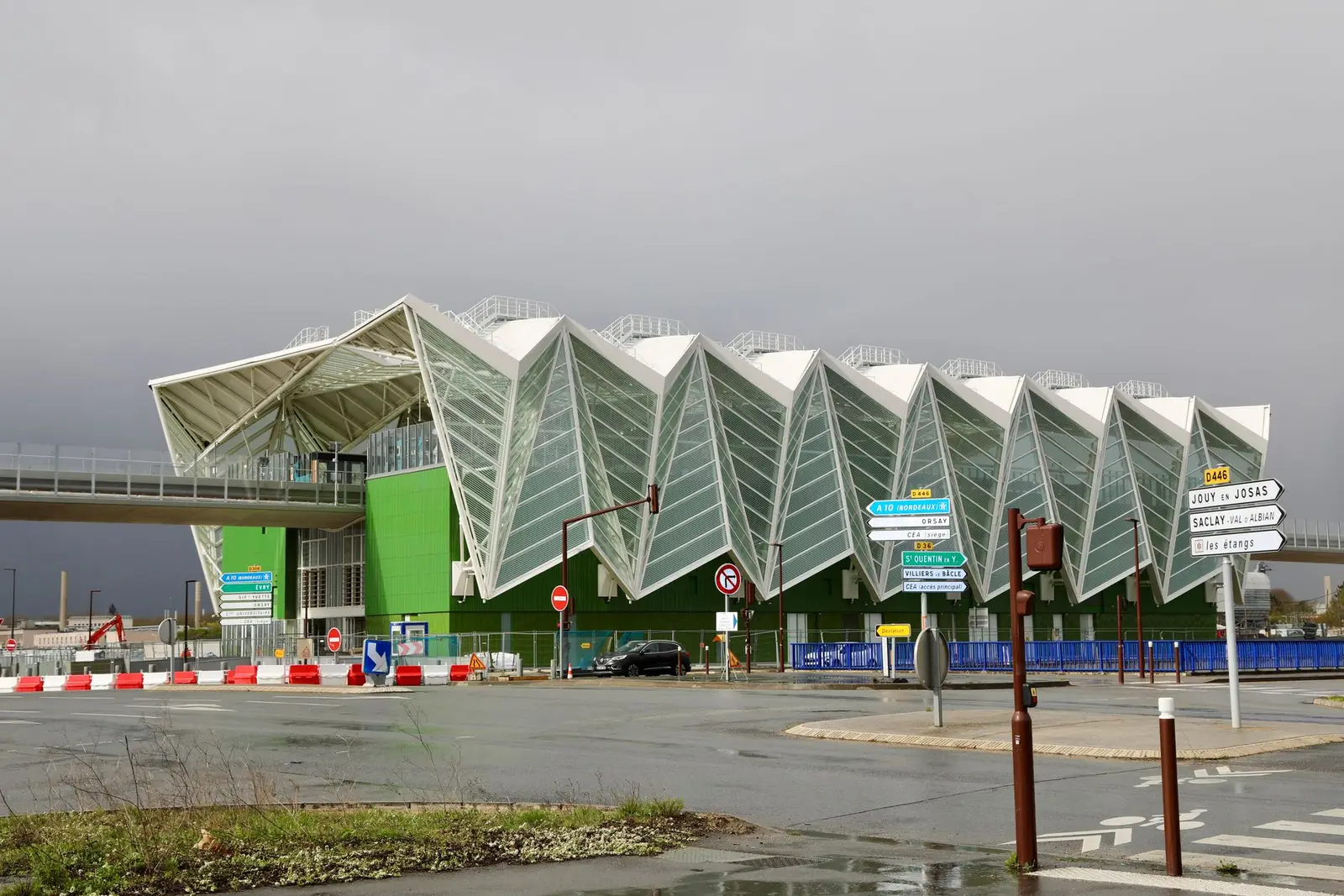 Bâtiment contemporain au toit en accordéon sur le plateau de Saclay, en Essonne, sous un ciel gris